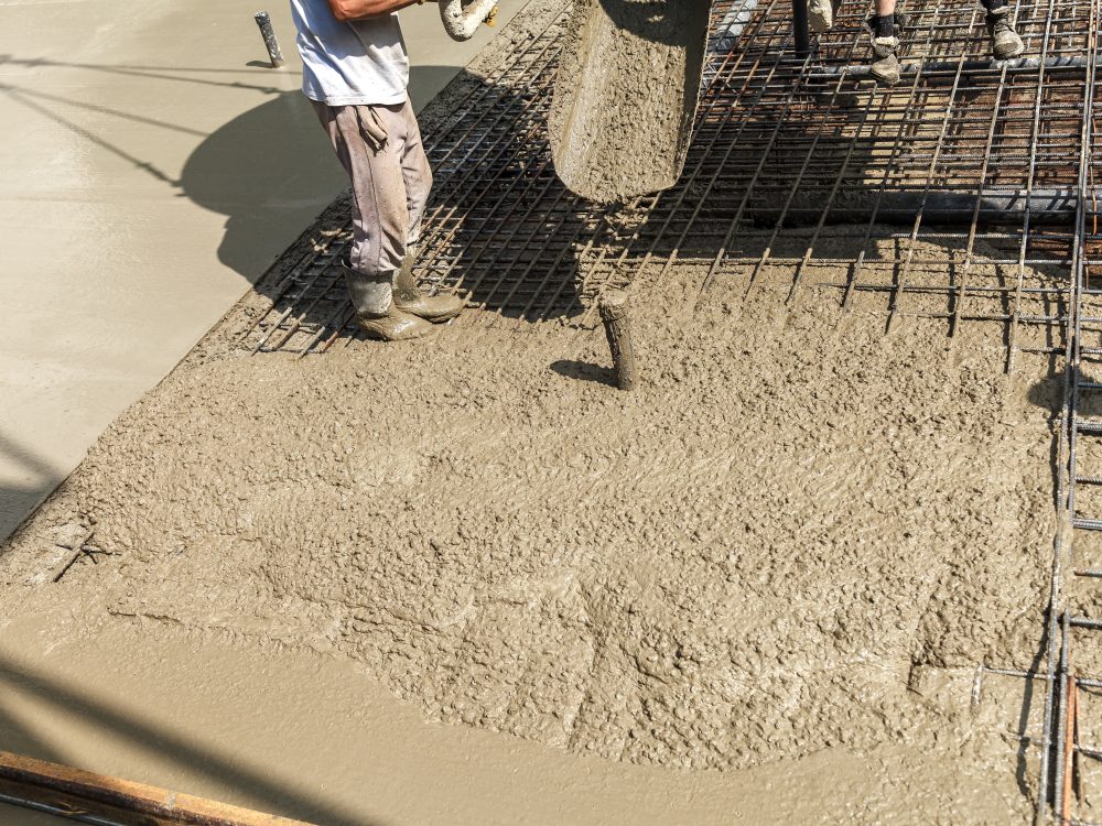 Pouring concrete into the construction of the house. Builders are pouring ready-mixed concrete